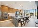 Marble kitchen island with seating, stainless steel appliances, and large window at 9701 E Happy Valley Rd # 10, Scottsdale, AZ 85255