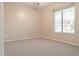 Simple bedroom with carpet, neutral walls, and a large window at 2405 W Minton St, Phoenix, AZ 85041