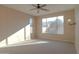 Bedroom with carpet, ceiling fan, and large window at 2405 W Minton St, Phoenix, AZ 85041