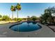 Relaxing kidney-shaped pool surrounded by a landscaped yard at 10472 W Alex Ave, Peoria, AZ 85382