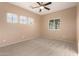 Bright bedroom with ceiling fan, carpet, and multiple windows at 10472 W Alex Ave, Peoria, AZ 85382