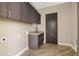 Laundry room with granite countertop and dark brown cabinets at 2526 W Fernwood Dr, Phoenix, AZ 85086