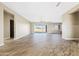 Bright and airy living area with wood-look tile flooring and access to the patio at 2526 W Fernwood Dr, Phoenix, AZ 85086