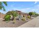 Landscaped front yard with drought-tolerant plants and a two-car garage at 4556 W South Butte Rd, San Tan Valley, AZ 85144