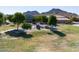 Community playground with play equipment, surrounded by trees at 4556 W South Butte Rd, San Tan Valley, AZ 85144