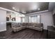 Open concept living room with a view into the kitchen and ample seating at 43856 N Hudson Trl, New River, AZ 85087