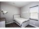 Charming bedroom with light wood bed frame and window coverings at 43856 N Hudson Trl, New River, AZ 85087