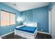 Bedroom with a full-size bed, window coverings, and blue walls at 43856 N Hudson Trl, New River, AZ 85087