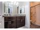 Bathroom with dark wood cabinets and a shower/tub combo at 43856 N Hudson Trl, New River, AZ 85087