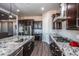 Kitchen features granite countertops, stainless steel appliances, and gas cooktop at 43856 N Hudson Trl, New River, AZ 85087