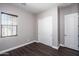 Well-lit bedroom with double door closet and wood flooring at 43856 N Hudson Trl, New River, AZ 85087