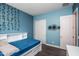 Bright bedroom with a double bed, built-in shelving, and a spacious closet at 43856 N Hudson Trl, New River, AZ 85087