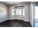 Bright dining room with bay window, wood floors, and modern light fixture at 43856 N Hudson Trl, New River, AZ 85087