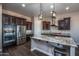 Modern kitchen with granite countertops, stainless steel appliances, and a large island at 43856 N Hudson Trl, New River, AZ 85087