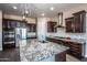 Modern kitchen with granite countertops and stainless steel appliances at 43856 N Hudson Trl, New River, AZ 85087