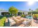 Outdoor fire pit and seating area near the pool at 6630 E Stallion Rd, Paradise Valley, AZ 85253