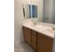 Double vanity bathroom with light wood cabinets and a large mirror at 5513 W San Gabriel Ave, Laveen, AZ 85339
