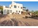 Two-story home with stone retaining wall and patio at 6275 E Jacob Waltz St, Apache Junction, AZ 85119