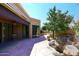 Spacious flagstone patio with seating area, mature trees, and a water feature at 23014 N 86Th St, Scottsdale, AZ 85255