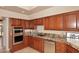 Well-equipped kitchen with granite countertops and wood cabinets at 23014 N 86Th St, Scottsdale, AZ 85255