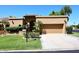 Spanish style home with landscaped lawn and two-car garage at 23014 N 86Th St, Scottsdale, AZ 85255
