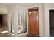 Elegant entryway with wood door and plantation shutters at 23014 N 86Th St, Scottsdale, AZ 85255