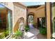 Charming courtyard entry with fountain and lush greenery at 23014 N 86Th St, Scottsdale, AZ 85255