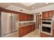 Kitchen boasting stainless steel appliances and wood cabinets at 23014 N 86Th St, Scottsdale, AZ 85255
