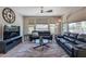 Spacious Gathering room with a large TV, comfortable seating, and lots of natural light at 36131 N Desert Tea Dr, Queen Creek, AZ 85140