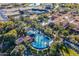 Aerial view showing resort-style pool, clubhouse, and lush landscaping at 36131 N Desert Tea Dr, Queen Creek, AZ 85140
