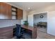 L-shaped desk and ample storage in a home office at 36131 N Desert Tea Dr, Queen Creek, AZ 85140