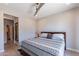 Spacious bedroom with a comfortable bed, dresser, and a view of the backyard at 36131 N Desert Tea Dr, Queen Creek, AZ 85140