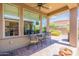 Covered patio with table and chairs, offering relaxing views at 36131 N Desert Tea Dr, Queen Creek, AZ 85140