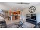 Comfortable living room features leather sofas, a large TV, and a coffee table at 36131 N Desert Tea Dr, Queen Creek, AZ 85140