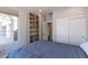Bedroom with a queen bed, built-in shelving, and large closet at 36131 N Desert Tea Dr, Queen Creek, AZ 85140