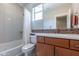 Updated bathroom with tub/shower combo and wood vanity at 36131 N Desert Tea Dr, Queen Creek, AZ 85140