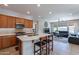 Open kitchen boasts an island with seating, stainless steel appliances, and stylish cabinetry at 36131 N Desert Tea Dr, Queen Creek, AZ 85140