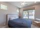 Bedroom with queen-sized bed and window overlooking backyard at 36131 N Desert Tea Dr, Queen Creek, AZ 85140