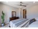 Comfortable bedroom with a queen bed, dresser and mirror, near bathroom at 36131 N Desert Tea Dr, Queen Creek, AZ 85140