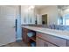 Double sink bathroom with wood cabinets and tile backsplash at 36131 N Desert Tea Dr, Queen Creek, AZ 85140