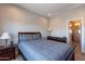 Comfortable bedroom with a double bed and ensuite bathroom at 36131 N Desert Tea Dr, Queen Creek, AZ 85140