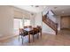 Spacious dining area with wood table and chairs, located near kitchen and staircase at 36131 N Desert Tea Dr, Queen Creek, AZ 85140