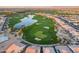 Aerial view of a golf course community with a lake and homes at 36131 N Desert Tea Dr, Queen Creek, AZ 85140