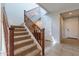 Elegant wooden staircase leading to the upper level at 36131 N Desert Tea Dr, Queen Creek, AZ 85140