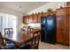 Kitchen with dark wood cabinets, black fridge and breakfast table at 412 E Dartmouth Dr, Casa Grande, AZ 85122