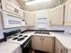 Clean and efficient kitchen, with white cabinets and a four-burner stove at 155 S Limestone Dr, Apache Junction, AZ 85119