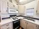 Bright kitchen features white cabinets, and modern appliances at 155 S Limestone Dr, Apache Junction, AZ 85119