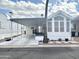 Single wide manufactured home with carport and landscaping at 155 S Limestone Dr, Apache Junction, AZ 85119
