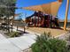 Modern playground with shade structures and play equipment at 16035 W Questa Dr, Surprise, AZ 85387