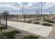 Well-lit pickleball court with chain link fence at 16035 W Questa Dr, Surprise, AZ 85387